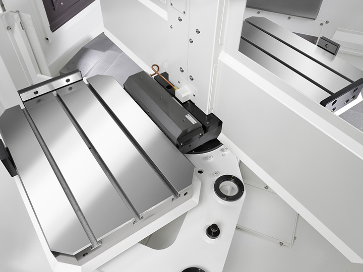 CNC machine tilting worktable with red arrows indicating rotational movement.