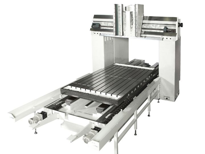 CNC machine frame with a large metal worktable and dual-column gantry structure.
