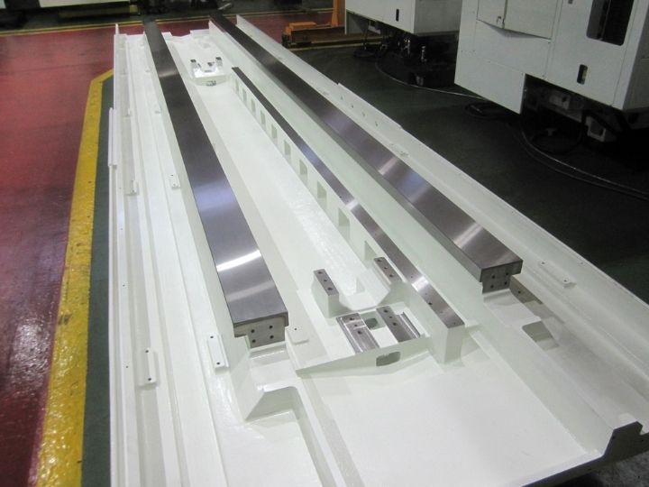CNC machine base with precision linear guide rails and mounting points.