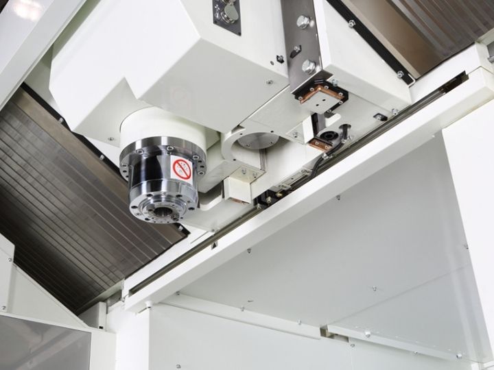 CNC machine overhead spindle assembly with precision linear guides.