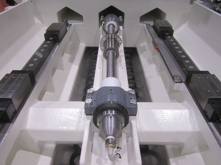 CNC machine ball screw assembly with linear rails and guide supports.
