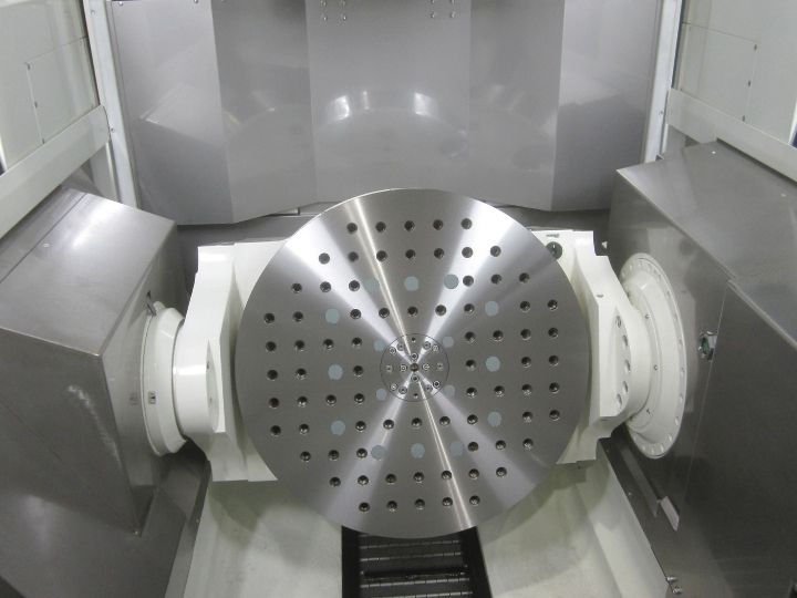 Kitamura Mytrunnion-5G rotary table with precision-drilled holes for secure workpiece mounting.