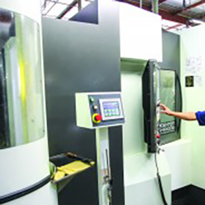 A person operating a manufacturing machine.