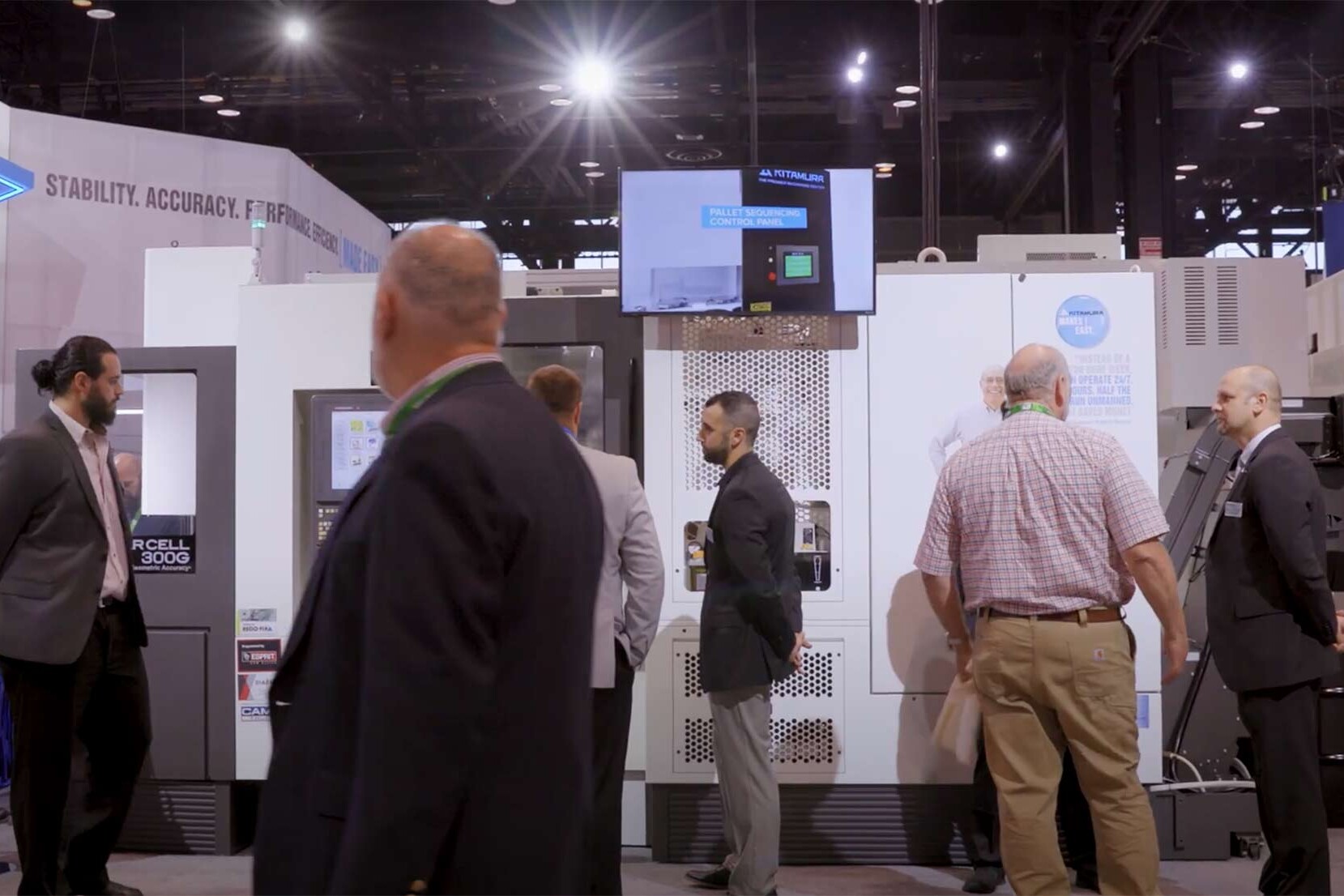 People attending a trade show for a machine manufacturing company.