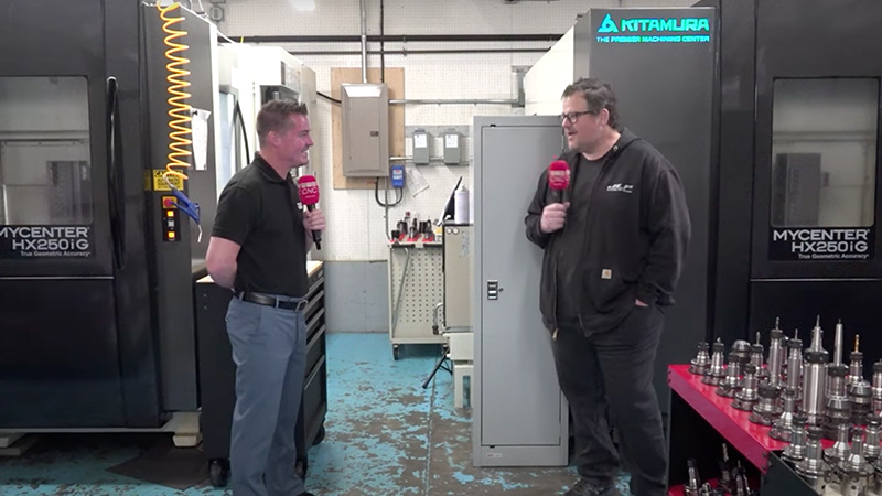 Two people having a conversation about industrial machines.