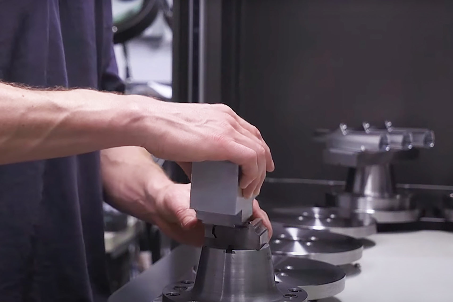 A person assembling a machine.