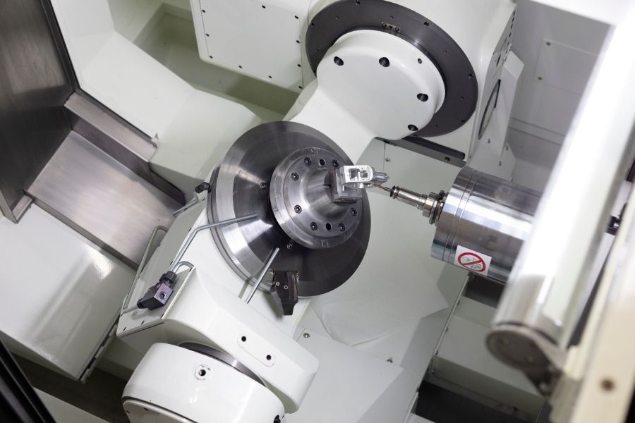 A close-up view of a 5-axis CNC machining center, showcasing the rotating spindle and tool head for precision metalworking operations.