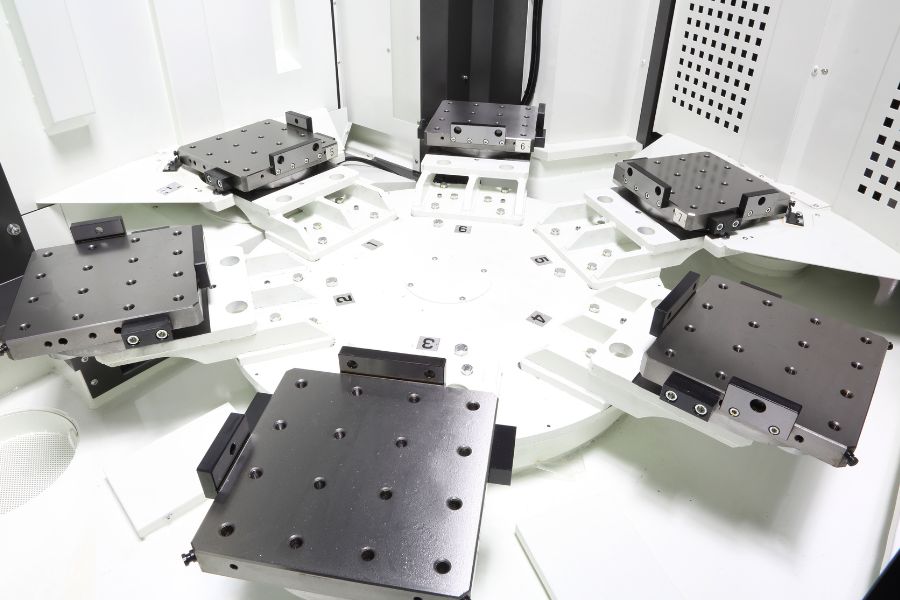 Interior of a horizontal machining center featuring a multi-station pallet system with multiple fixture plates for high-efficiency part loading.