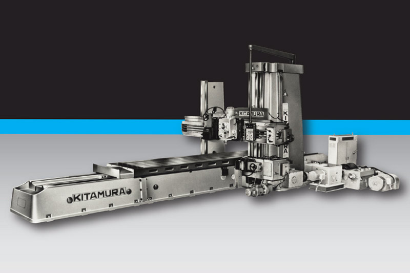 Vintage Kitamura gantry-style milling machine with labeled components, demonstrating early engineering and machine tool heritage.