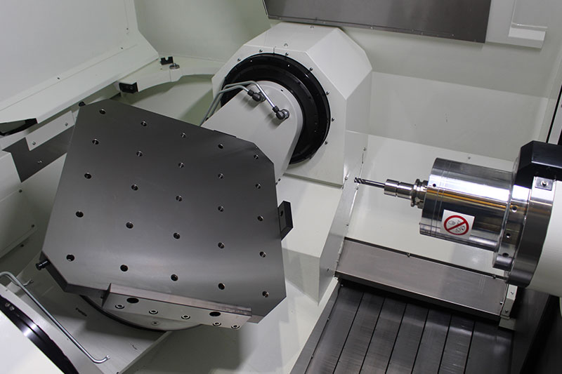 nterior view of a Kitamura 5-axis CNC machining center, showing a tilted rotary table and high-precision spindle ready for operation.