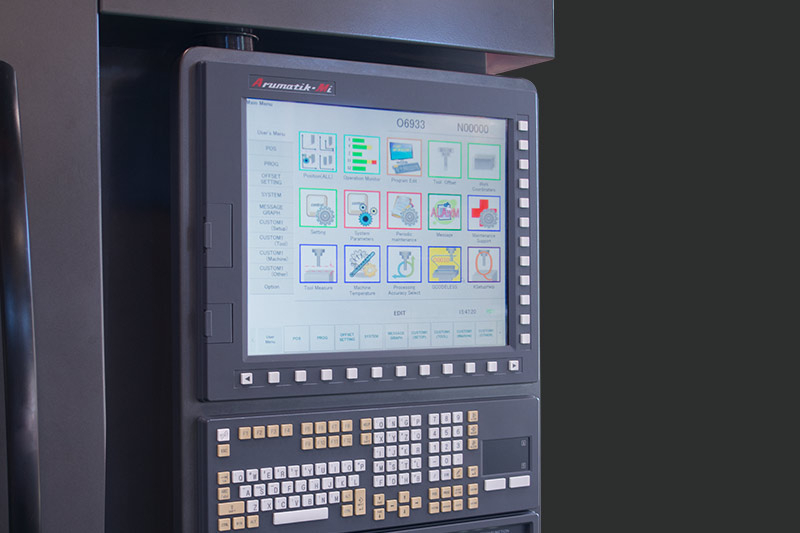 Close-up view of the Arumatik-Mi CNC control panel featuring a touchscreen interface with colorful icons and a full keypad.